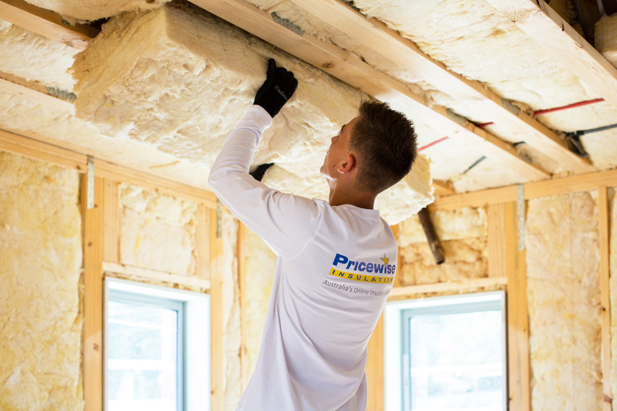 Man insulating an energy efficient home